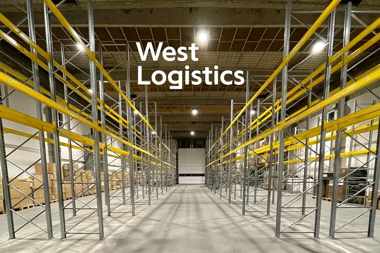 Picture of empty warehouse racks with West Logistics logo