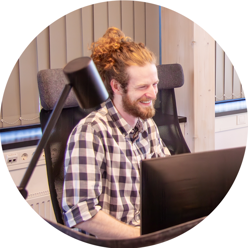 Picture of smiling man in front of computer doing customer support for Ongoing