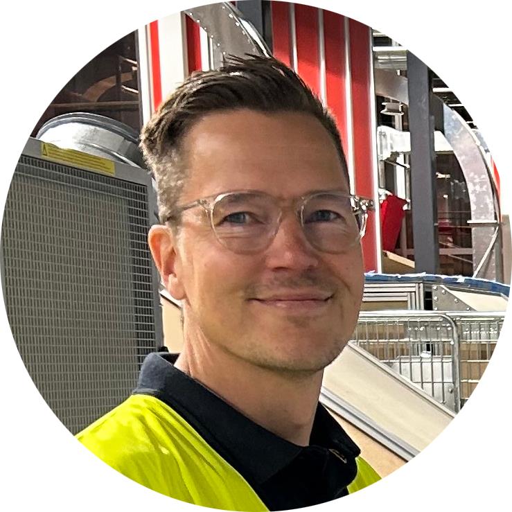 Portrait picture of smiling man in warehouse environment