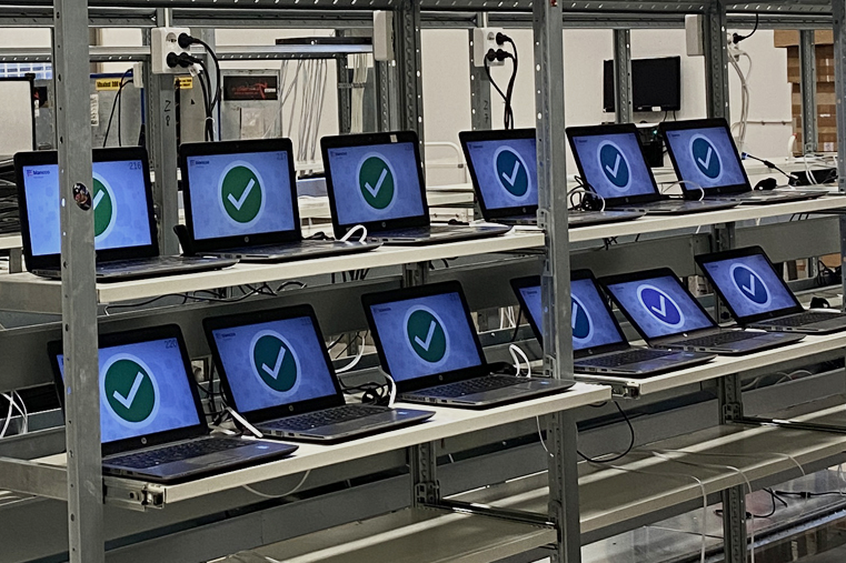 Rows of laptops undergoing testing and quality control