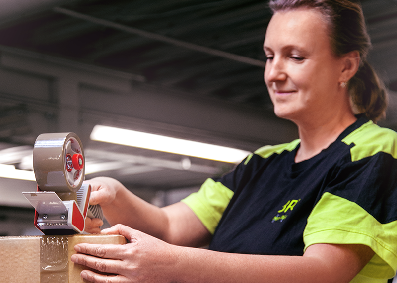 Employee sealing package in warehouse