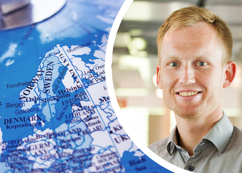 Picture of a map next to a portrait picutre of smiling man