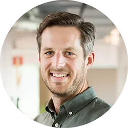 Professional headshot of a man in an office environment