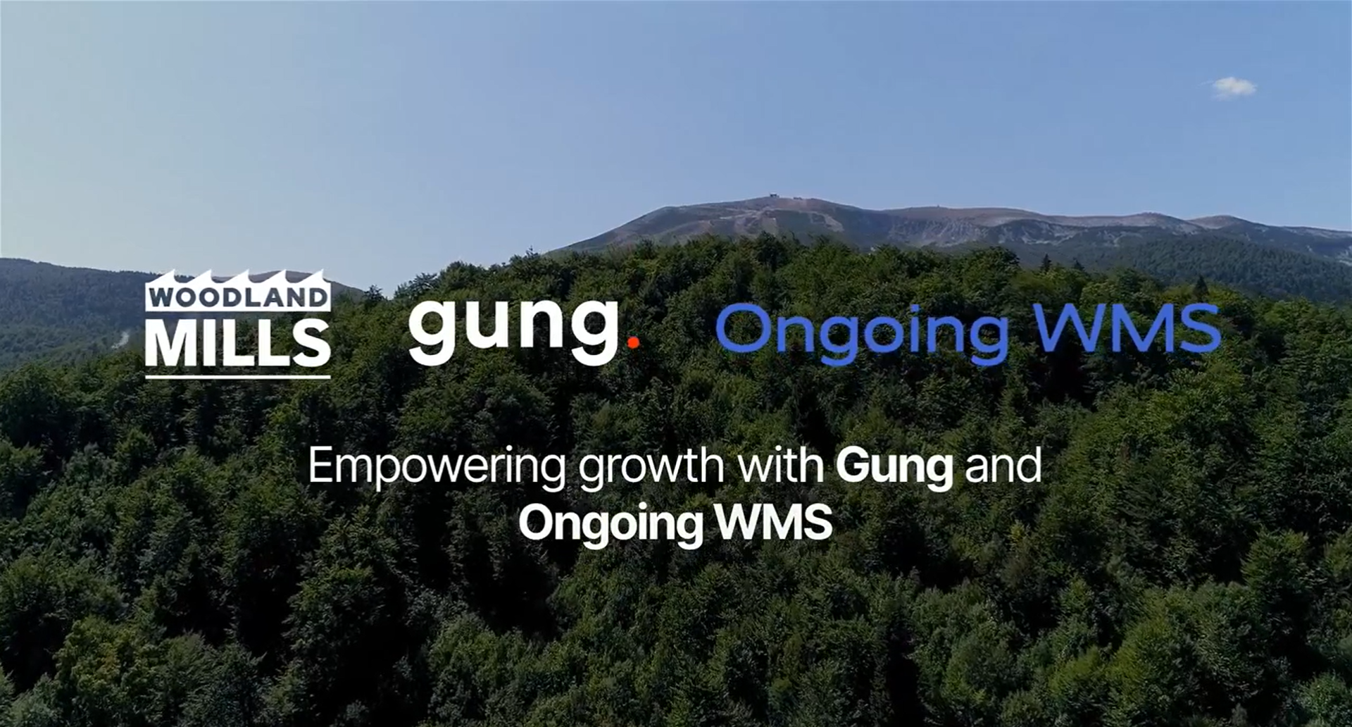Woodland Mills, Gung and Ongoing WMS logos with growth message over forest and mountain background