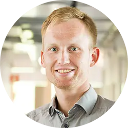 Professional headshot of a man in an office environment