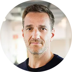 Professional headshot of a man in an office environment